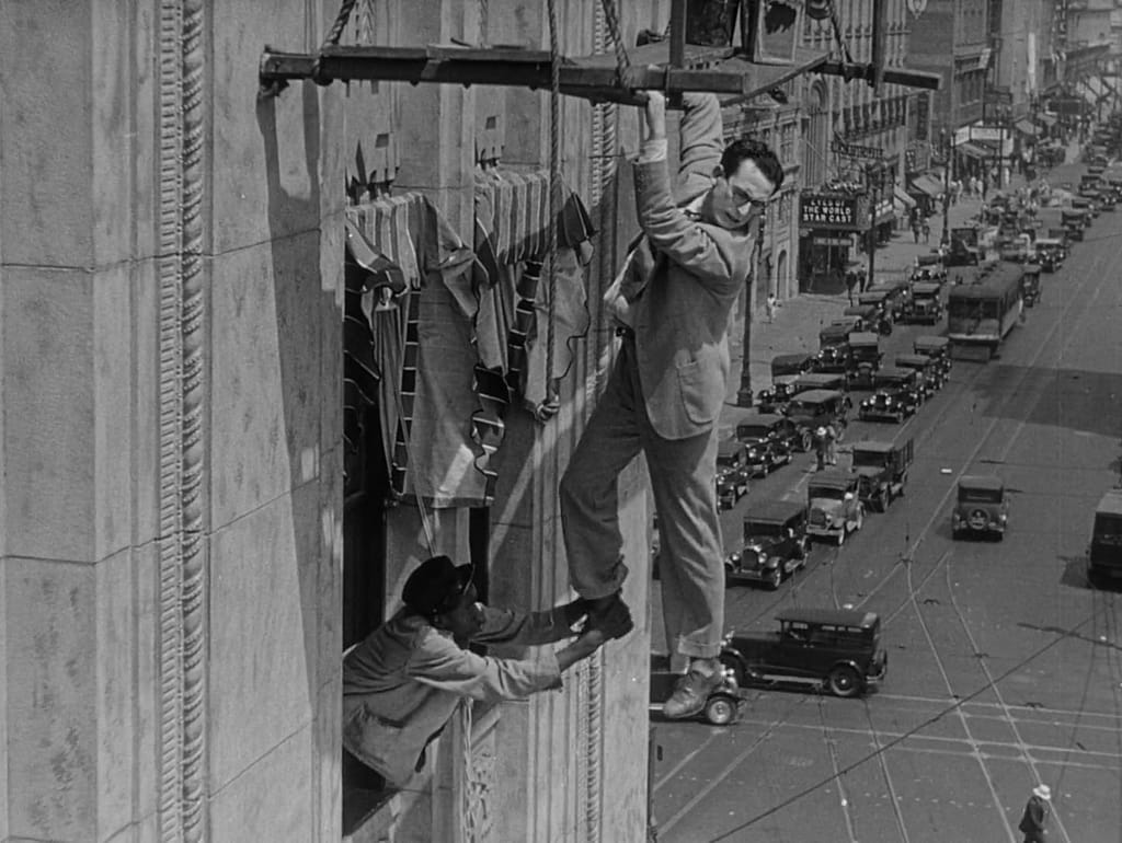 Harold Lloyd dangling from a building in Feet First.