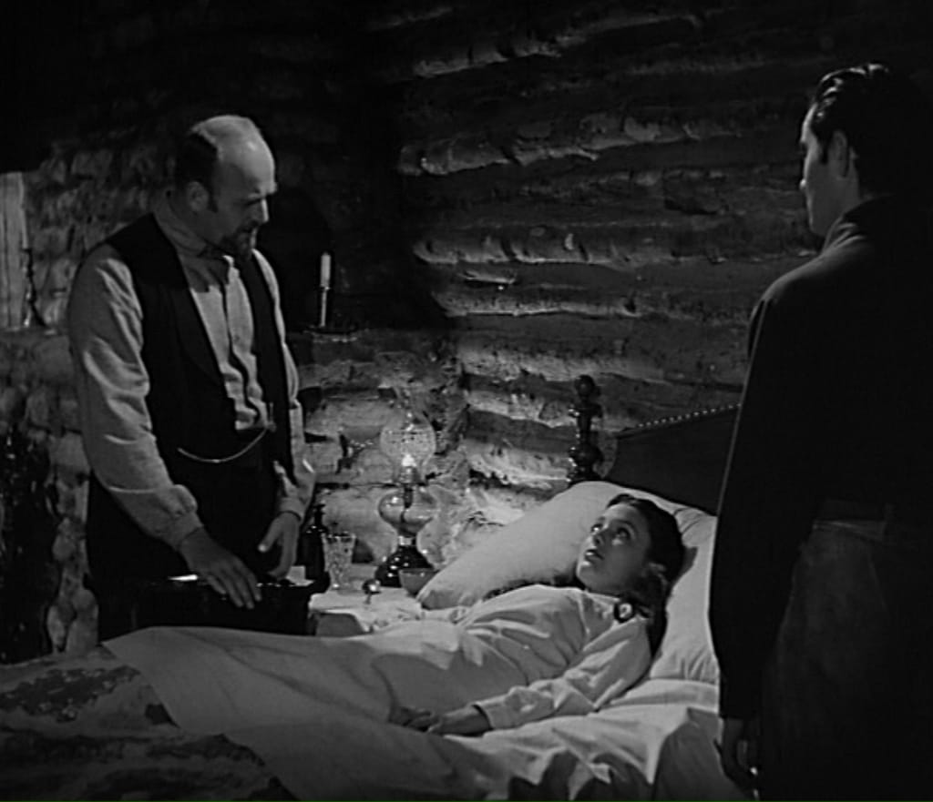 Moroni Olsen (left) the only Mormon actor in Brigham Young standing aside Linda Darnell's bed.