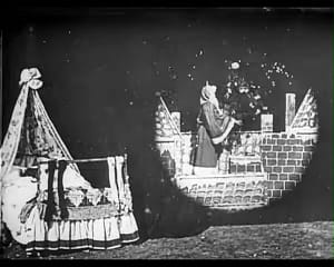 A frame from Brighton School filmmaker George Albert Smith's 1898 film Santa Claus with Santa climbing down the chimney to deliver presents.