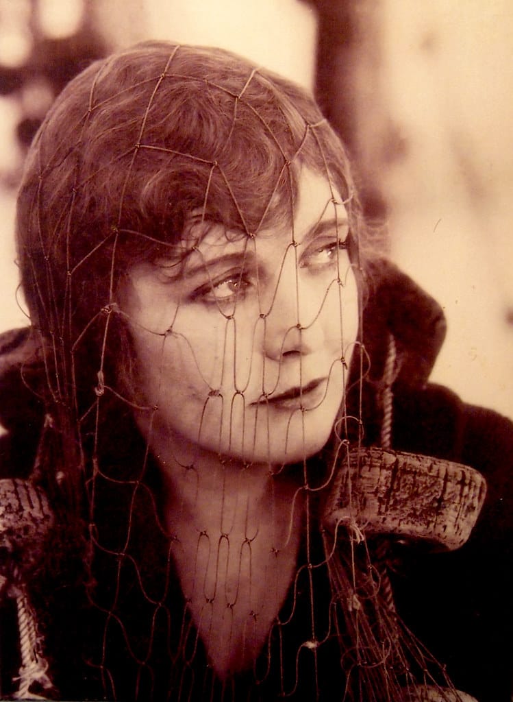 Edna Purviance wearing a fishnet in a still from one of Chaplin's only two lost silent films.